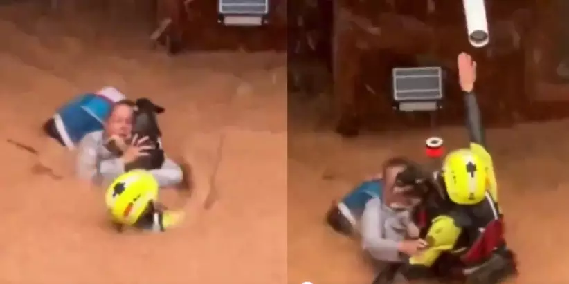 Mulher se recusa a abandonar cachorro durante enchente na Espanha e é resgatada por bombeiros